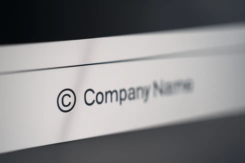 A webpage footer featuring a precise copyright notice illustrating the standard format.