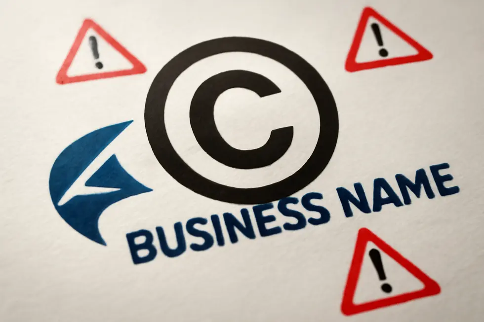 A business owner reviewing trademark protections for their name and logo with a legal expert.